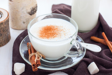 Homemade kefir in a glass cup with cinnamon and sugar, horizontal