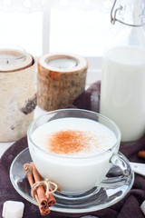 Homemade kefir in a glass cup with cinnamon and sugar, selective focus