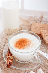 Homemade kefir in a glass cup with cinnamon and sugar, selective focus