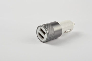 USB car adapter, phone charger on white background 