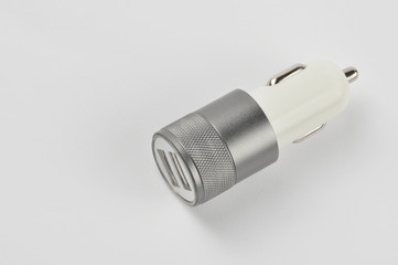 USB car adapter, phone charger on white background 