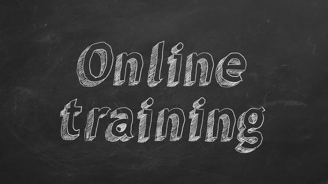 Hand drawing "Online training" on black chalkboard. Stop motion animation.