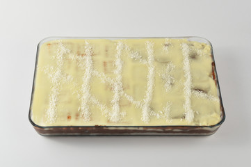 Homemade cake in a glass bowl isolated on white background
