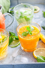 Cold tangerine juice with pulp on the background of summer cold citrus drinks, selective focus