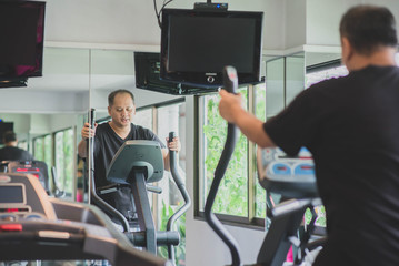 Asian man work out exercise at Gym weight loss