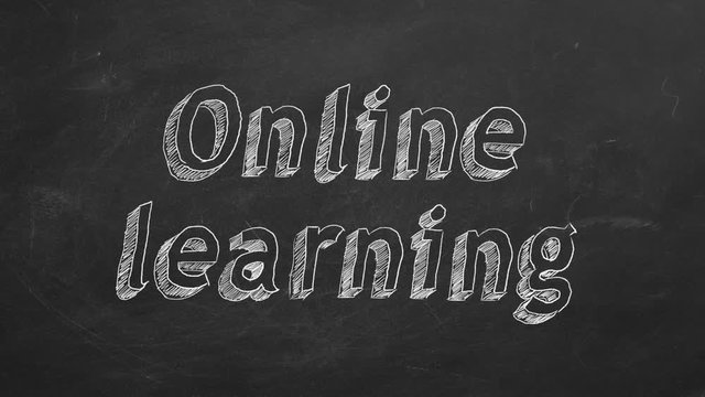 Hand drawing "Online learning" on black chalkboard. Stop motion animation.