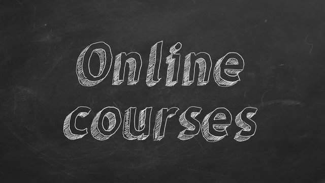 Hand drawing "Online courses" on black chalkboard. Stop motion animation.