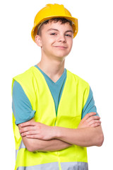 Funny Handsome Teen Boy wearing Safety Jacket and yellow Hard Hat. Portrait of Happy Child keeps arm folded and Looking at Camera, isolated on white background.