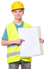 Funny Handsome Teen Boy wearing Safety Jacket and yellow Hard Hat. Portrait of Happy Child with blank board Looking at Camera, isolated on white background.