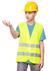Funny Handsome Teen Boy wearing Safety Jacket and yellow Hard Hat. Portrait of Happy Child Makes Hands Gesture and Looking away, isolated on white background.
