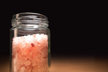 Pink salt from Bolivian in a glass jar close up