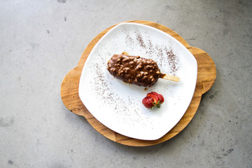 chocolate and almond coated ice cream on a plate