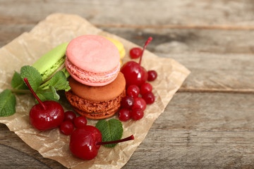 Tasty macarons on wooden background