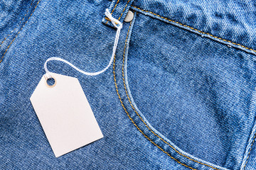 Stylish jeans with blank tag, closeup