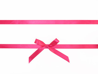 Two pink satin ribbon horizontally with bow on white background