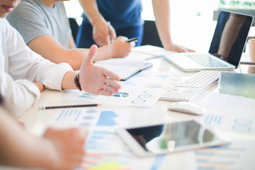 Close up of hands and stationery of Business people counting on calculator sitting at the table