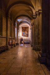 Fototapeta na wymiar Interior of the Lisbon Cathedral or Se de Lisboa aka Santa Maria Maior Church, Portugal. Romanesque aisle parallel to the nave with round arches