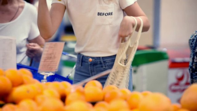 pretty girl woman picking veggies and fruits in supernarket in mesh organic shopping bag, zero waste , eco friendly