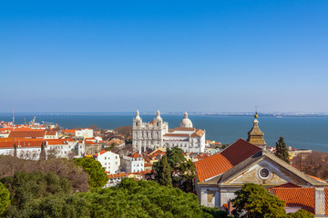 Lisbon, Portugal. Sao Vicente de Fora Monastery, dome of Panteao Nacional aka National Panteon and Tagus river. Santa Cruz do Castelo church in foreground.