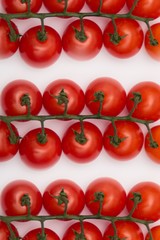 Fresh juicy red cherry tomato bunch closeup isolated on white background. 