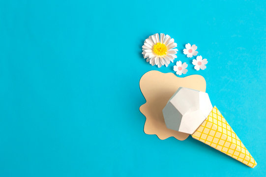 Ice cream in waffle cone and flowers made of paper