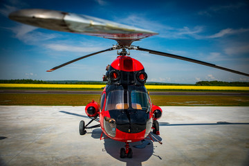 red and black helicopter standing at the airfield