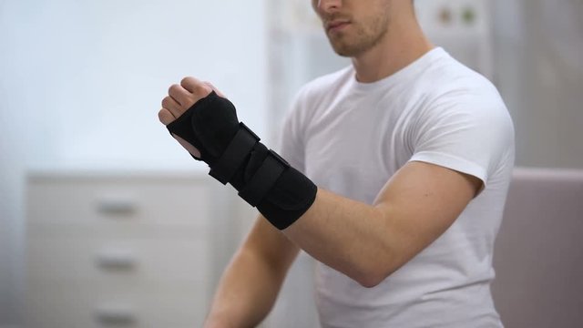 Sportsman fixing titan wrist support, inflammation or sprain, orthopedics