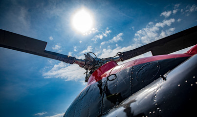 red and black helicopter standing at the airfield motor close up