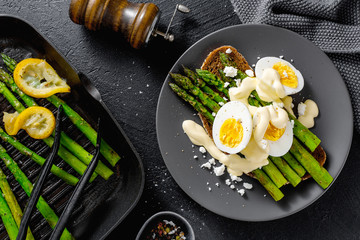 Tasty toasts with asparagus, eggs and sauce