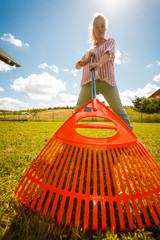 Unusual angle of woman raking leaves