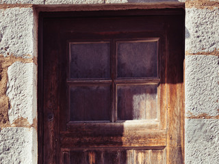 Old wooden door with window