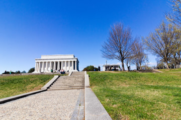 Spring vista of the historic Lincoln Memorial from the ceremonial boulevard of the National Mall in Washington