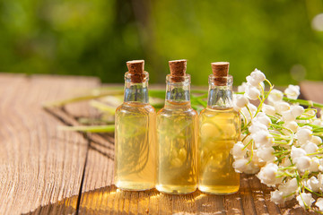 Essence of flowers on table in beautiful glass jar