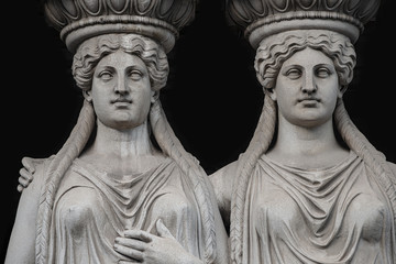 Statue of two sensual Roman renaissance era women at Parliament building in Vienna, Austria,...