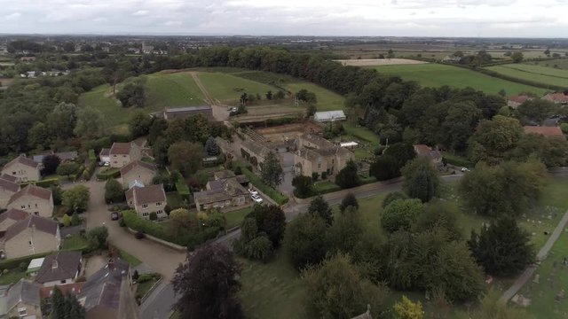 Drone revealing a church in a village in Bramham, Yorkshire