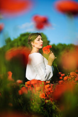 beautiful woman in a field of poppies