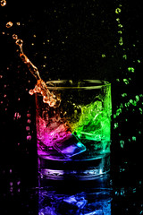 Isolated shot of whiskey with splash on black background