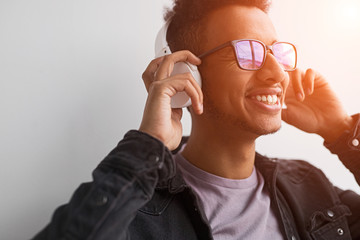 Fototapeta premium Smiling black guy listening to good music