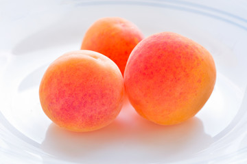 Organic dried fresh apricots on white in vintage style