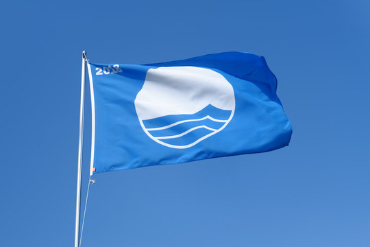 Waving blue flag. The Blue Flag is a certification that a beach, marina or sustainable boating tourism operator meets its stringent standards.