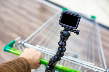 Food concept blogger. Video recording of a person recording a shopping trip with a shopping cart on camera. Diet, technology, health, food, cooking, cooking, people, shopping, blogging.