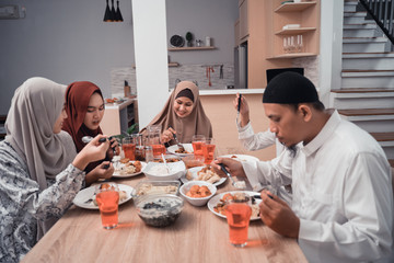 asian muslim family iftar dinner together at home. break fasting concept