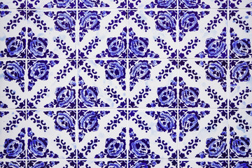 Gorgeous traditional Portuguese ceramic blue tiles with floral pattern. Vintage glazed tiles texture and background.