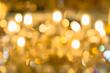 Blurred abstract background of Christmas lights.Brightly glowing yellow-orange balls and lines.Abstract color patterns