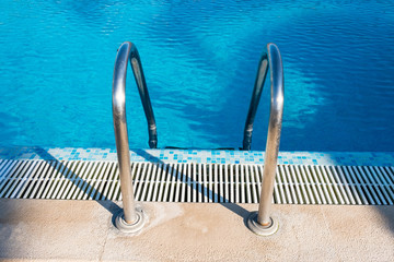 swimming pool stair in blue water at hotel