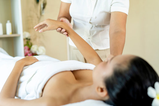 physiotherapist or Beautician massaging hand of female spa salon client or pressing specific spots on palm. Start up, Health Care ,Spa Beauty treatment, lifestyle modern woman concept