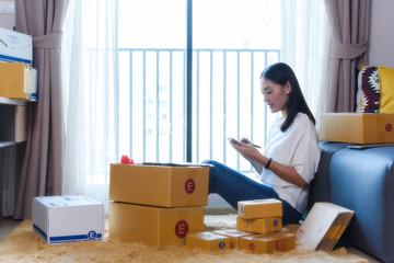 Young businesswoman, SME startup at home preparing goods and product for delivery