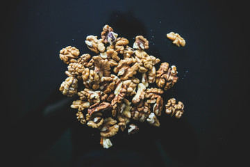 Walnuts on the black background.