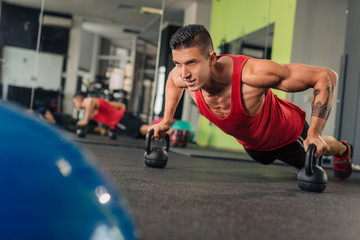 Young muscular man in the gym doing exercise
