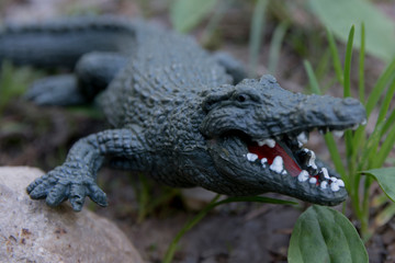 Decorative crocodile in the garden. Rubber statuette of a green crocodile